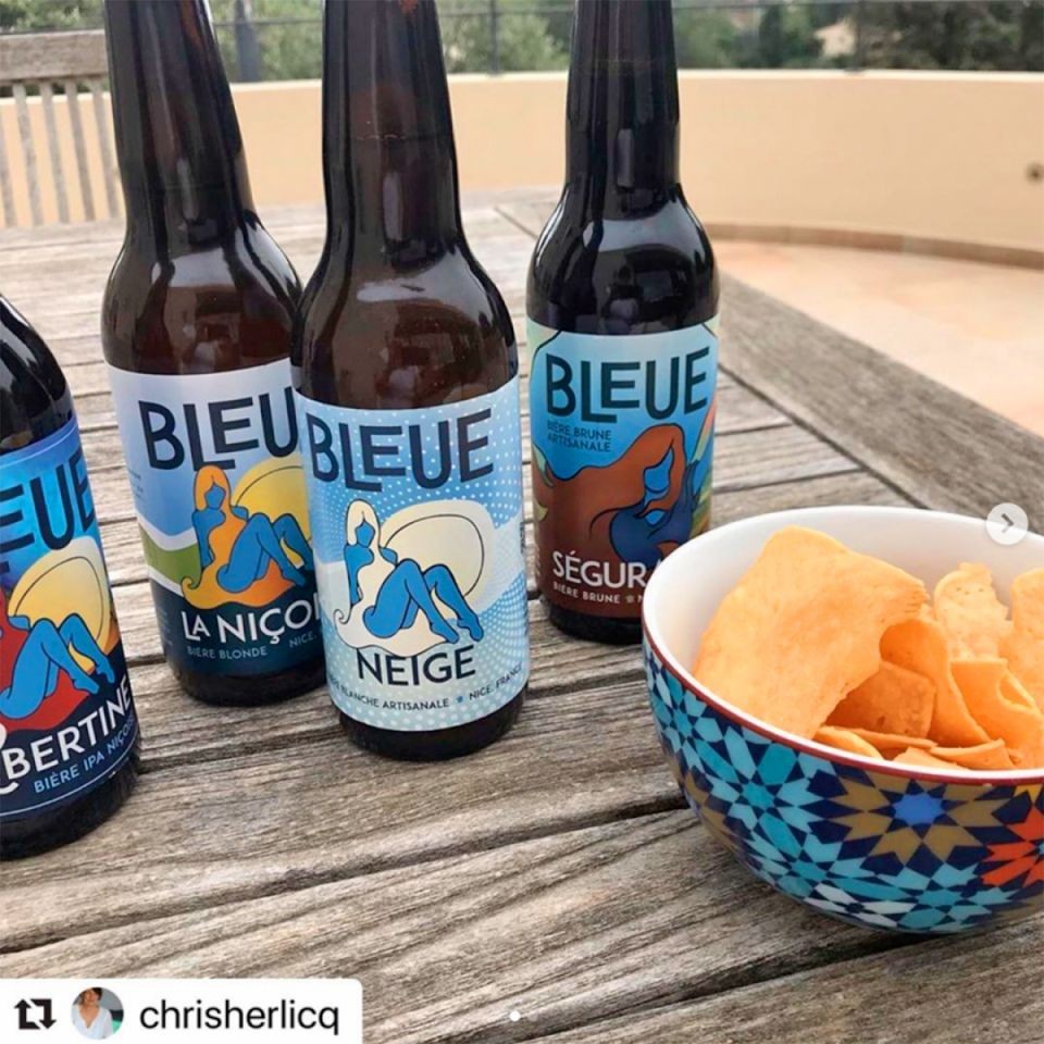 Bottles of beer from the brasserie BLEUE on a table.